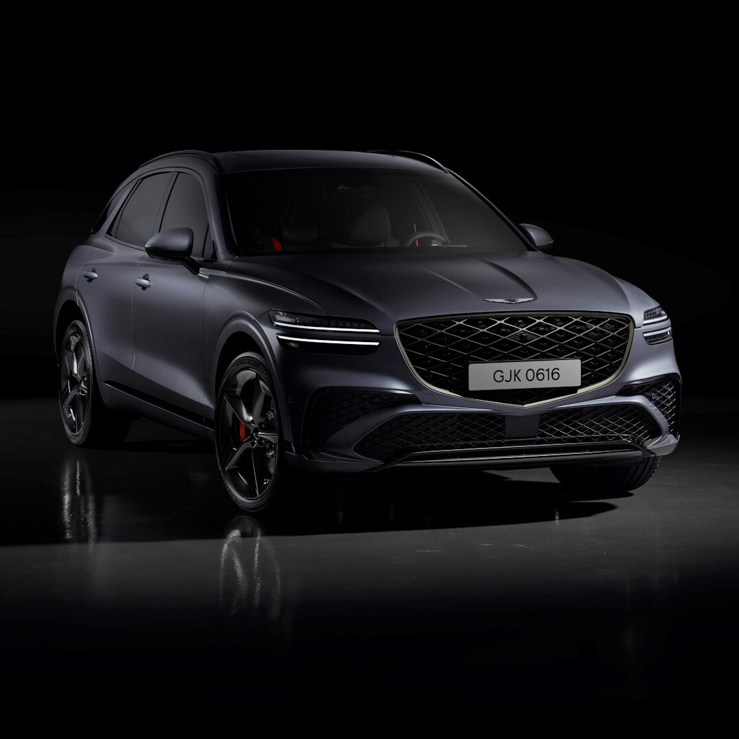 Modern hypercar photographed in a dark studio with dramatic rim lighting