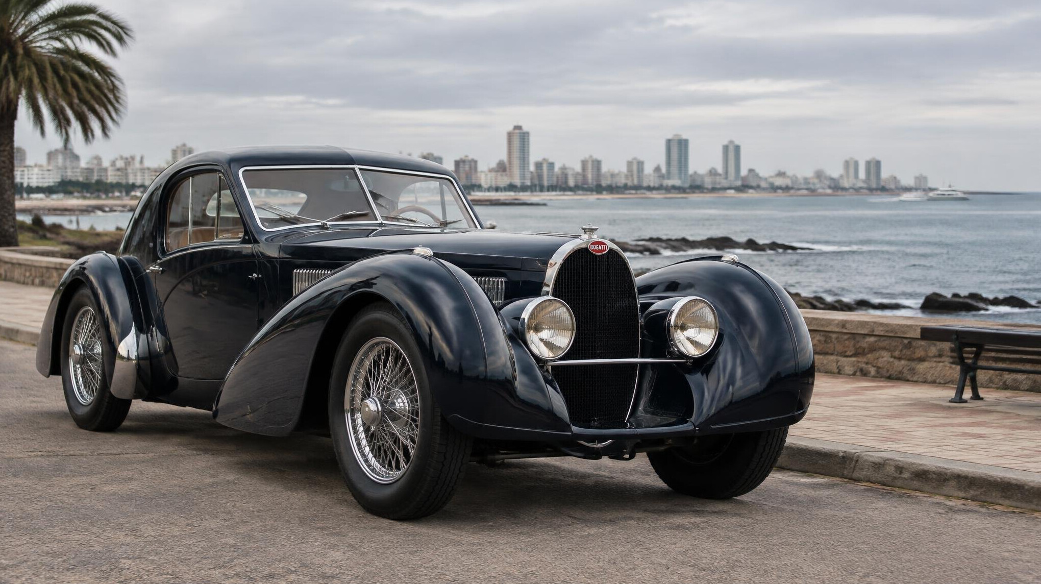 Elegant vintage Bugatti parked near a seaside promenade