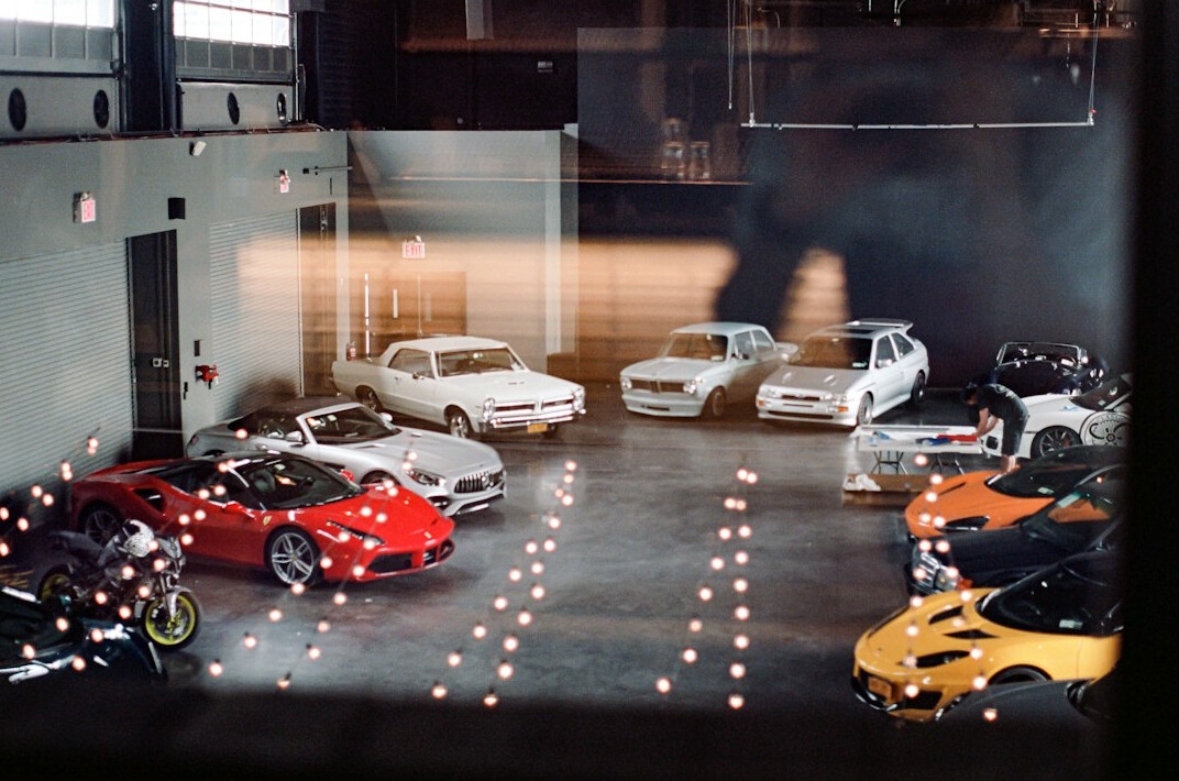 Private garage collection of classic and exotic cars under warm ambient lighting