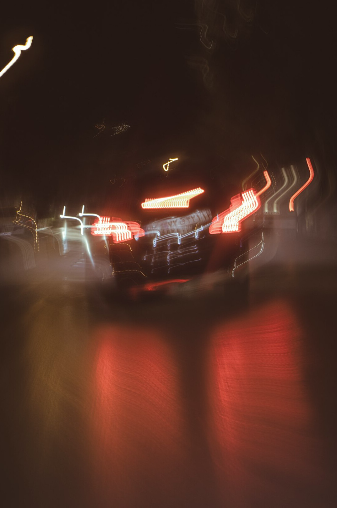 Electric hypercar photographed at night with glowing light trails