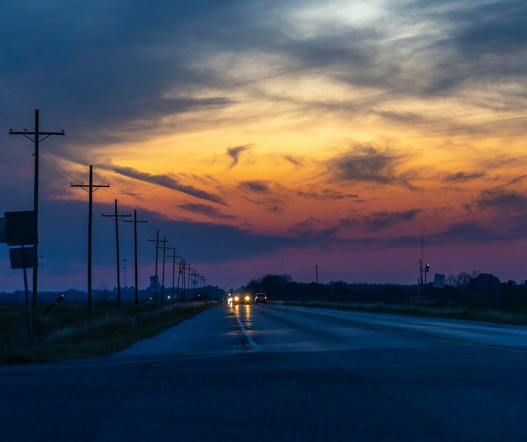 car on road at sunset