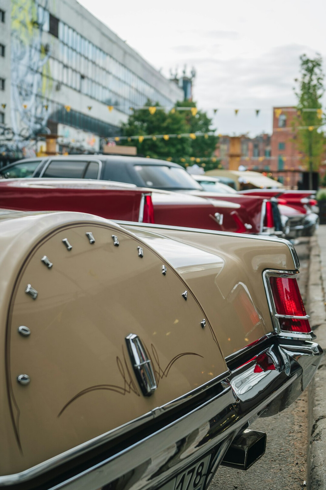 Row of restored vintage automobiles from different decades parked side by side